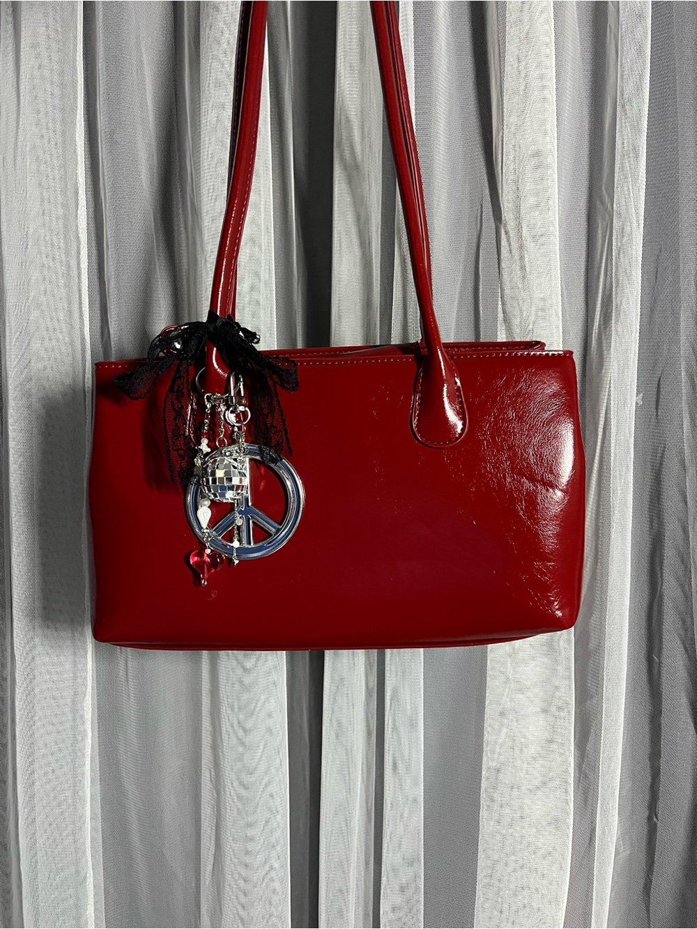 red patent shoulder bag with charms